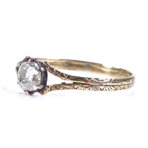 429 - A Georgian unmarked gold solitaire diamond ring, with floral engraved shoulders and shank, diamond a... 