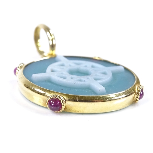 439 - A circular relief carved green agate pendant, with cabochon ruby set 18ct gold frame, pendant diamet... 