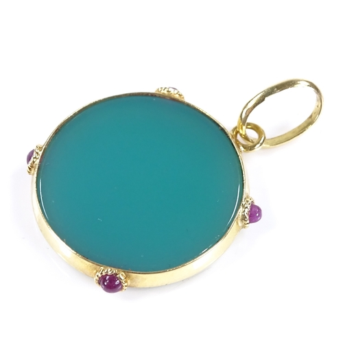 439 - A circular relief carved green agate pendant, with cabochon ruby set 18ct gold frame, pendant diamet... 