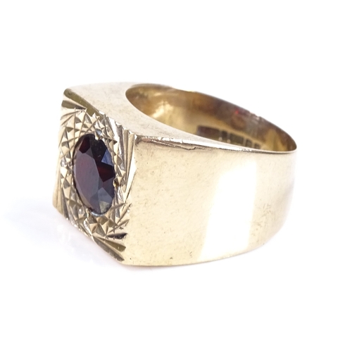 440 - A large 9ct gold garnet signet ring, setting height 13.7mm, size P, 8.4g