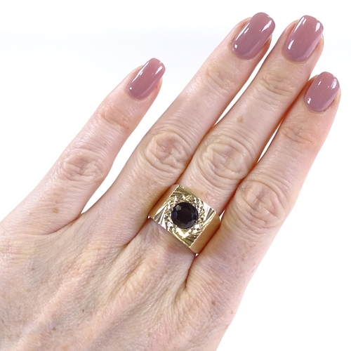 440 - A large 9ct gold garnet signet ring, setting height 13.7mm, size P, 8.4g