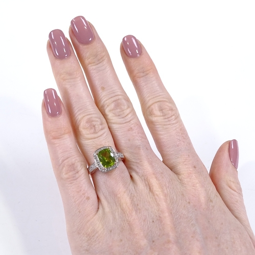 451 - A 14ct rose gold peridot and diamond dress ring, with diamond set shoulders and bridge, setting heig... 