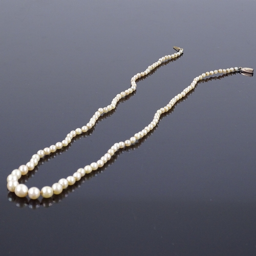 457 - A graduated single strand matinee pearl necklace, with unmarked gold rose-cut diamond set clasp, lar... 