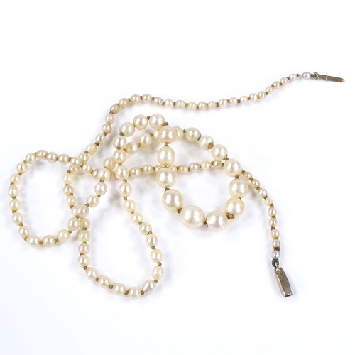 457 - A graduated single strand matinee pearl necklace, with unmarked gold rose-cut diamond set clasp, lar... 