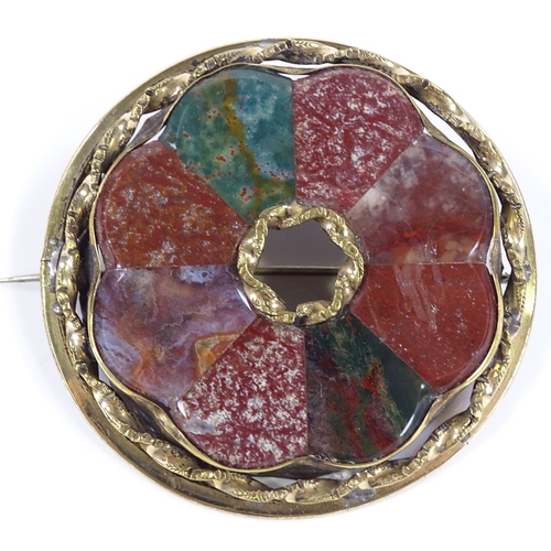 460 - A Scottish hardstone circular brooch, set with bloodstones and agates, in unmarked yellow metal sett... 