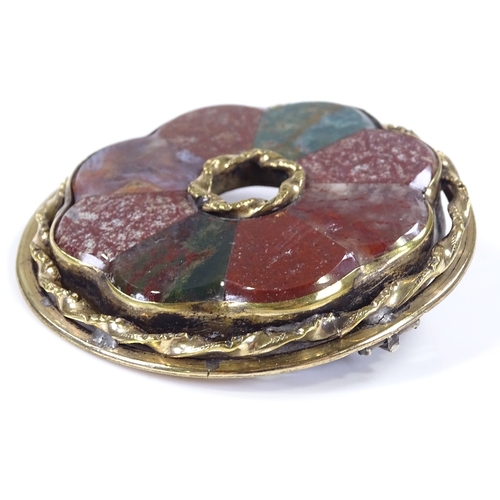 460 - A Scottish hardstone circular brooch, set with bloodstones and agates, in unmarked yellow metal sett... 