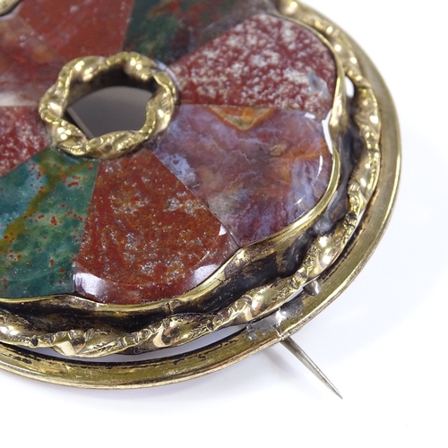 460 - A Scottish hardstone circular brooch, set with bloodstones and agates, in unmarked yellow metal sett... 