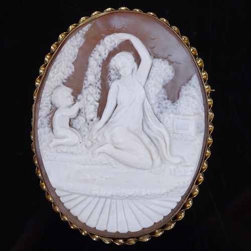 461 - A relief carved cameo panel brooch, depicting Classical maiden and boy, in 9ct gold twist frame, pan... 