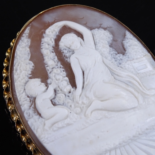 461 - A relief carved cameo panel brooch, depicting Classical maiden and boy, in 9ct gold twist frame, pan... 