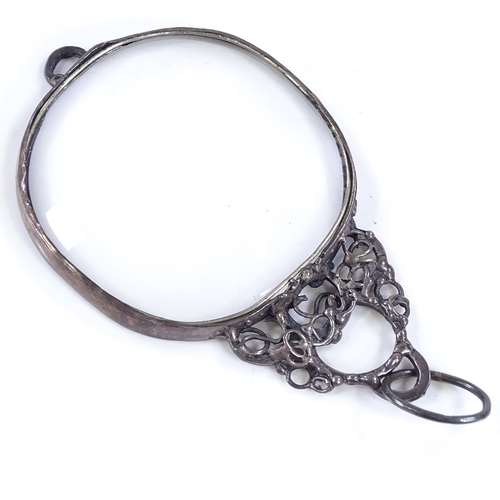 465 - A 1970s silver-mounted magnifying glass, with openwork stylised settings, maker's marks GB, hallmark... 