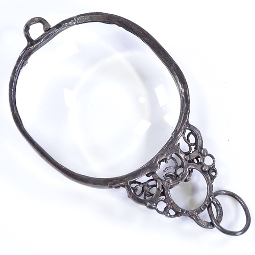 465 - A 1970s silver-mounted magnifying glass, with openwork stylised settings, maker's marks GB, hallmark... 