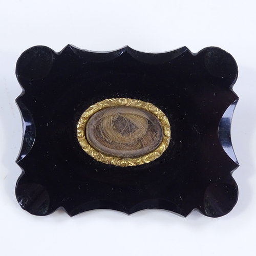 473 - A Victorian jet panel mourning brooch, with central crystal covered hair panel, brooch length 44.6mm... 