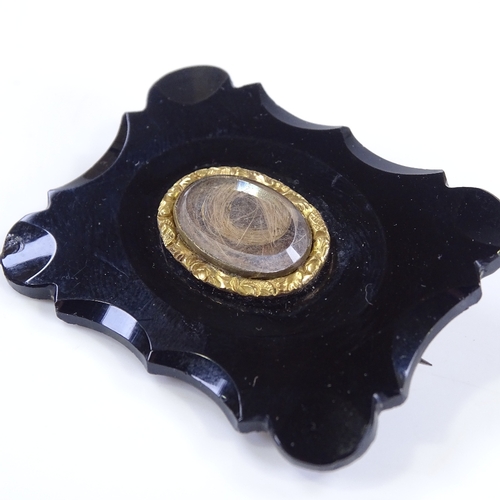 473 - A Victorian jet panel mourning brooch, with central crystal covered hair panel, brooch length 44.6mm... 