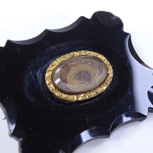 473 - A Victorian jet panel mourning brooch, with central crystal covered hair panel, brooch length 44.6mm... 