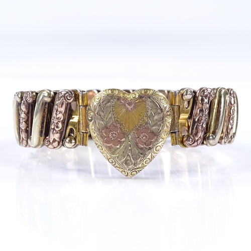 479 - An Antique silver and gold plated expanding heart clasp bracelet, with engraved floral decoration, u... 