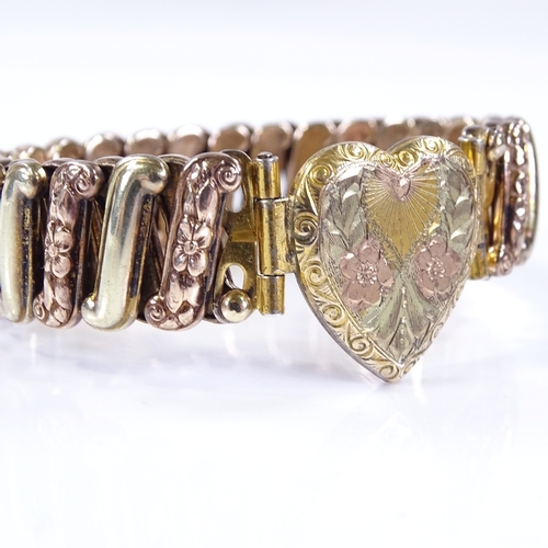 479 - An Antique silver and gold plated expanding heart clasp bracelet, with engraved floral decoration, u... 