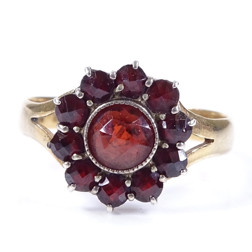 480 - An 18ct gold faceted garnet cluster ring, setting height 13.4mm, size S, 3.3g