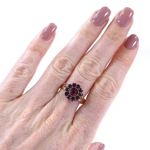 480 - An 18ct gold faceted garnet cluster ring, setting height 13.4mm, size S, 3.3g