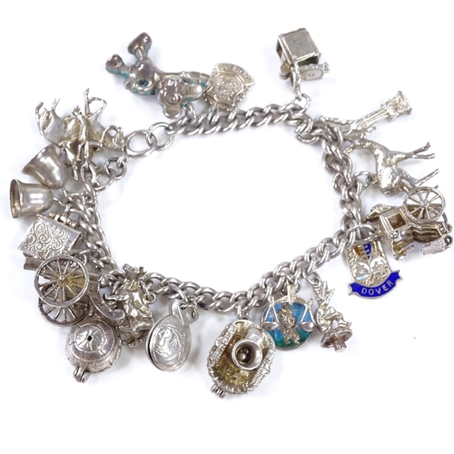 483 - A silver charm bracelet, with various charms, 66.9g