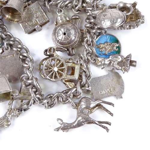 483 - A silver charm bracelet, with various charms, 66.9g