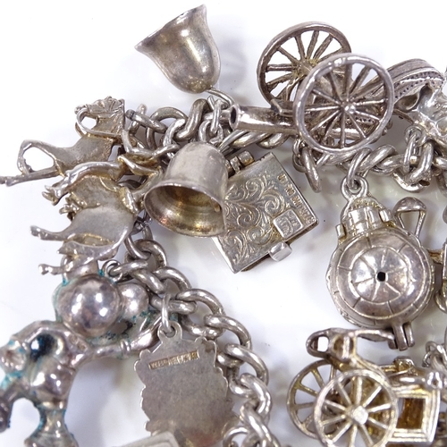 483 - A silver charm bracelet, with various charms, 66.9g