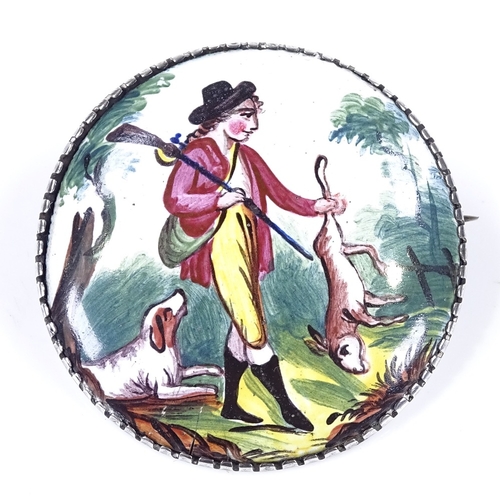 500 - A late Georgian painted enamel hunting brooch, depicting game hunter with dog, unmarked silver frame... 