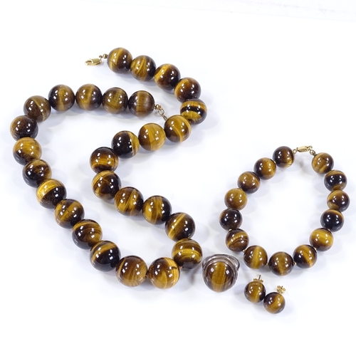 502 - A suite of polished tiger's eye bead jewellery, including necklace, bracelet, earrings and ring, nec... 