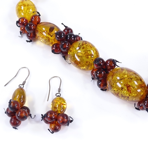 504 - An amber bead necklace, together with a matching pair of earrings (2)