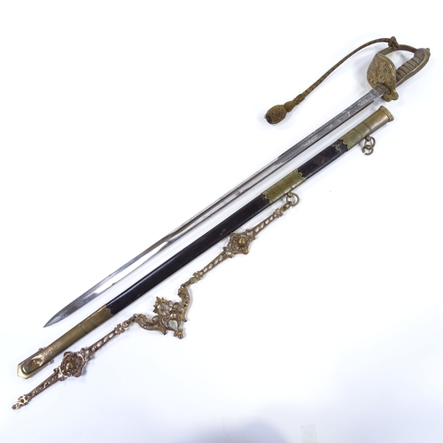 17 - An Edward VII Navy dress sword by E Goldman of Devonport, with etched blade, brass bowl hilt with sh... 