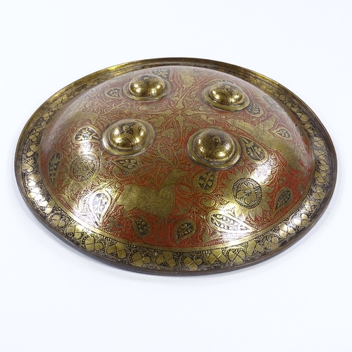 24 - An Islamic engraved brass and enamel shield, diameter 37cm