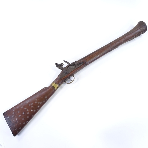 25 - An Antique Indian Flintlock Blunderbuss, with engraved barrel, lock stamped T Potts London, brass mo... 