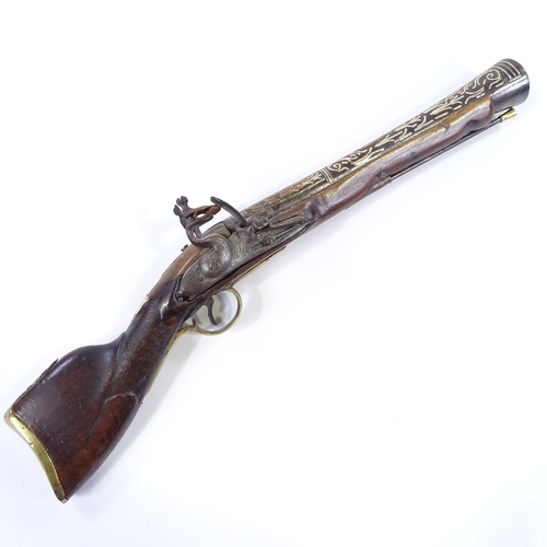 26 - An Antique Indian Flintlock Blunderbuss pistol, silver inlaid barrel, with engraved lock and brass m... 