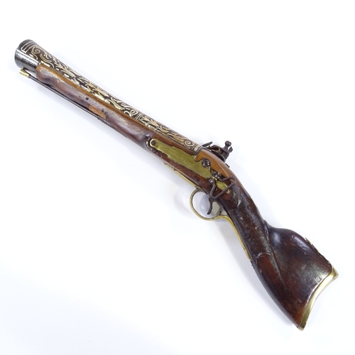 26 - An Antique Indian Flintlock Blunderbuss pistol, silver inlaid barrel, with engraved lock and brass m... 