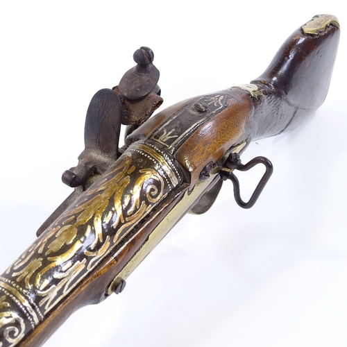 26 - An Antique Indian Flintlock Blunderbuss pistol, silver inlaid barrel, with engraved lock and brass m... 