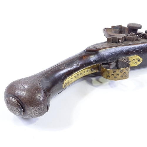 27 - A Middle Eastern Flintlock pistol, engraved barrel with engraved lock and brass mounts, length 44cm