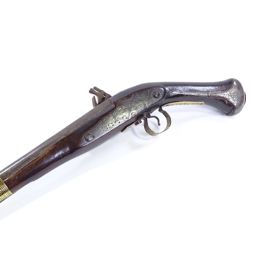 27 - A Middle Eastern Flintlock pistol, engraved barrel with engraved lock and brass mounts, length 44cm