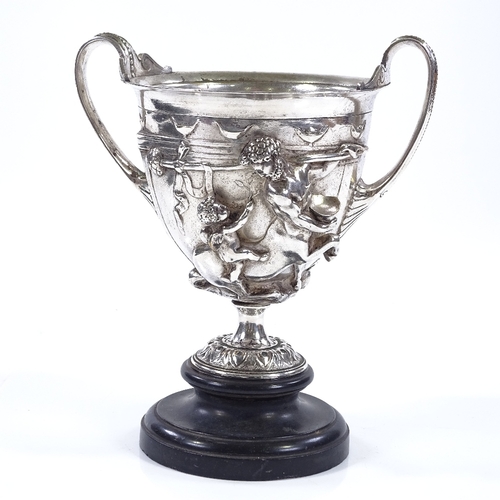 74 - A 19th century electroplate 2-handled cup, decorated with Classical figures in high relief, on circu... 