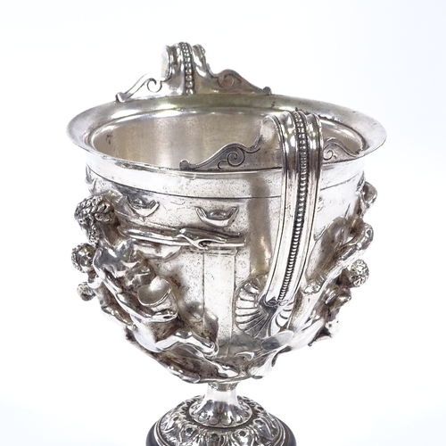 74 - A 19th century electroplate 2-handled cup, decorated with Classical figures in high relief, on circu... 