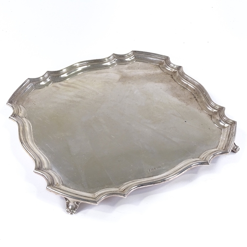 838 - A large George VI square silver tray, with scalloped edge and scrolled foliate feet, by Walker & Hal... 