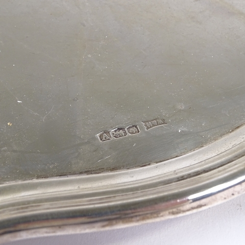 838 - A large George VI square silver tray, with scalloped edge and scrolled foliate feet, by Walker & Hal... 