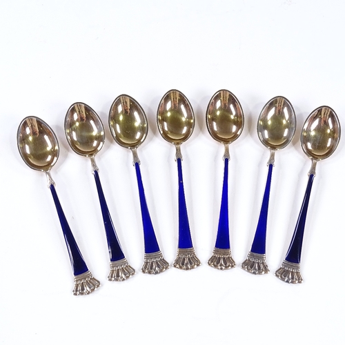 846 - A set of 7 Danish sterling silver-gilt and blue enamel coffee spoons, with crown terminals, by ELA, ... 