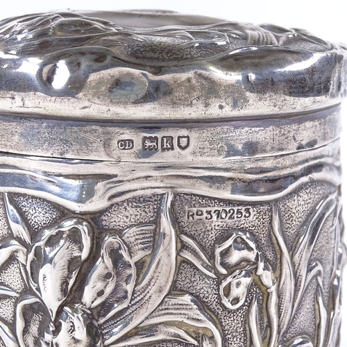 853 - An Art Nouveau Edwardian cylindrical silver lidded box, with relief embossed floral decoration, by C... 