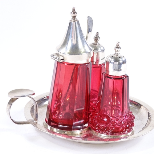 854 - A modern silver and cranberry glass cruet set, on silver fitted tray, maker's marks JW, hallmarks Bi... 