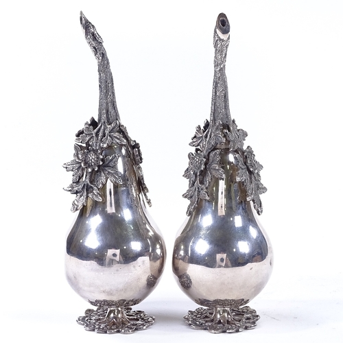 859 - A pair of Islamic silver rose water sprinklers, in the form of a pear, with cast-silver floral decor... 