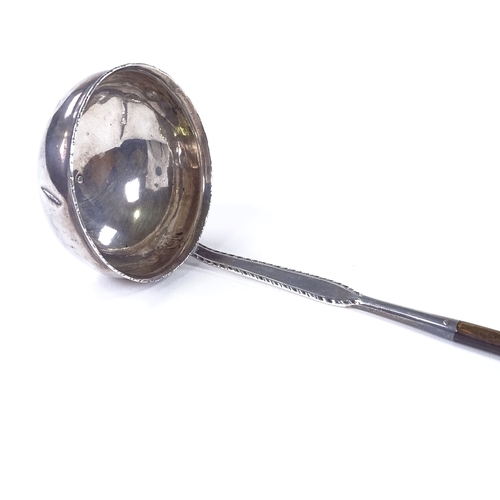 860 - A Georgian silver toddy ladle, with twisted whale bone handle, maker's marks WS, length 31cm