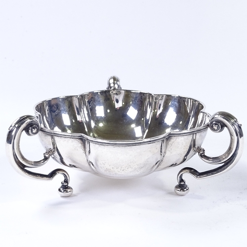 864 - An Edwardian circular silver lobed bowl, with 3 C-handles, by Horace Woodward & Co for Mappin & Webb... 