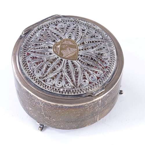 873 - An Iraqi silver circular dressing table box, with applied gold heart panel and filigree surround, di... 