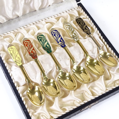 875 - A set of 6 Danish sterling silver-gilt and coloured enamel teaspoons, with stylised floral handles, ... 