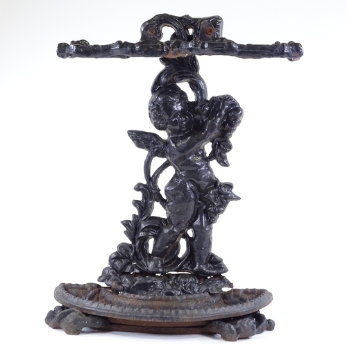 100 - A cast-iron stick stand with cherub support