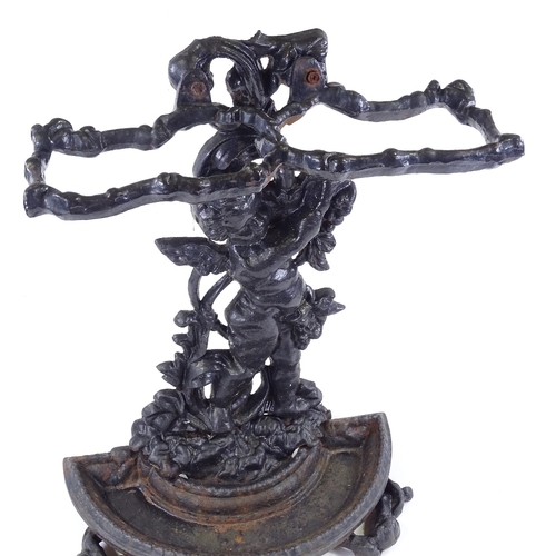 100 - A cast-iron stick stand with cherub support